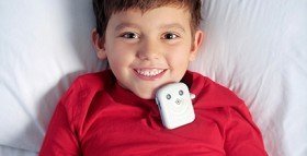Bedwetting alarms attached onto a boy's pajama top